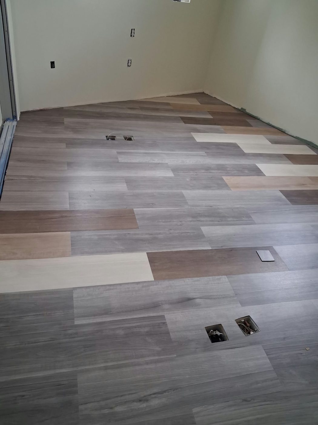 Multitone plank flooring across a room