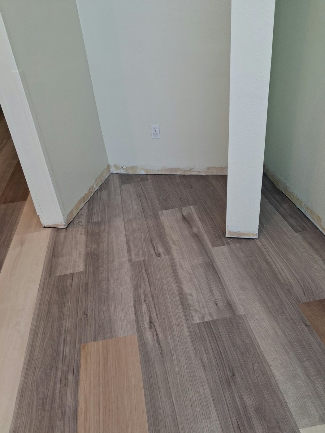 Installed flooring continuing through a hallway